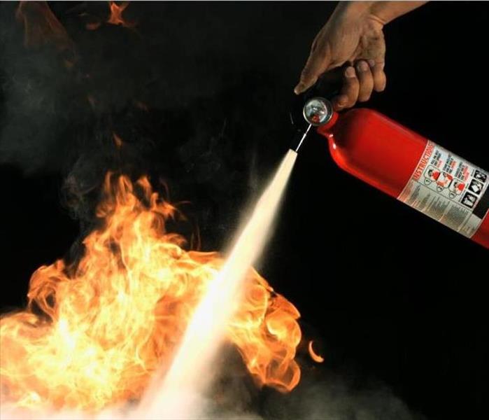 A fire being put out using a fire extinguisher 